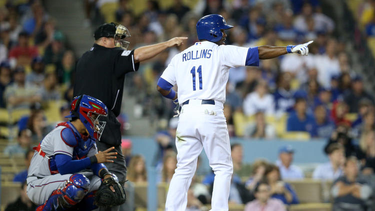 "Dodgers shortstop Jimmy Rollins and Umpire Marvin Hudson both point to Texas reliever Keone Kela after a balk in the ninth inning, which brought in the winning run.  The Dodgers beat the Rangers, 1-0. (Stephen Dunn / Getty Images)" - Dylan Hernandez  (http://www.latimes.com/sports/dodgers/la-sp-dodgers-20150619-story.html)